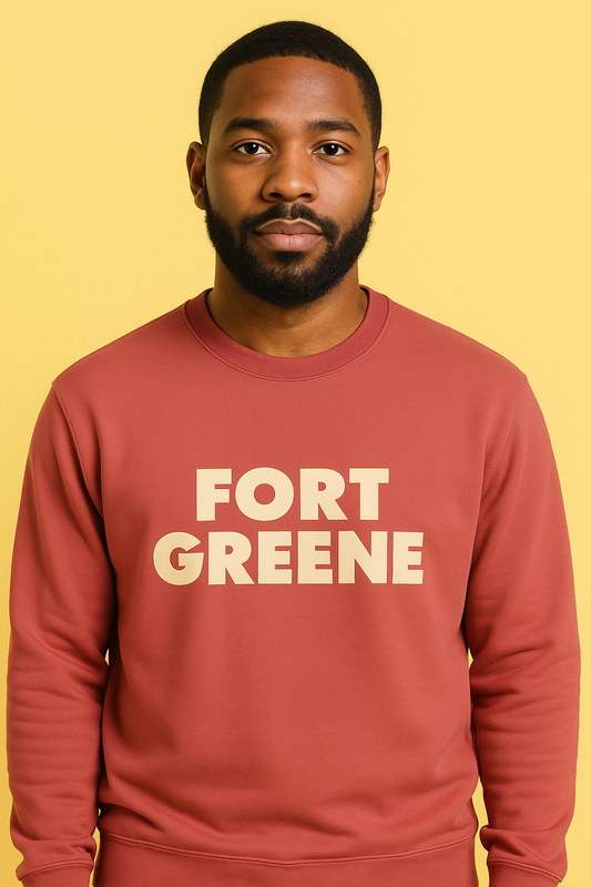Man wearing a red sweatshirt with 'FORT GREENE' text on a yellow background